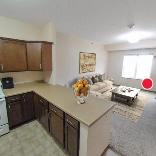 Bright open kitchen and living area with comfortable seating and natural light fostering community.