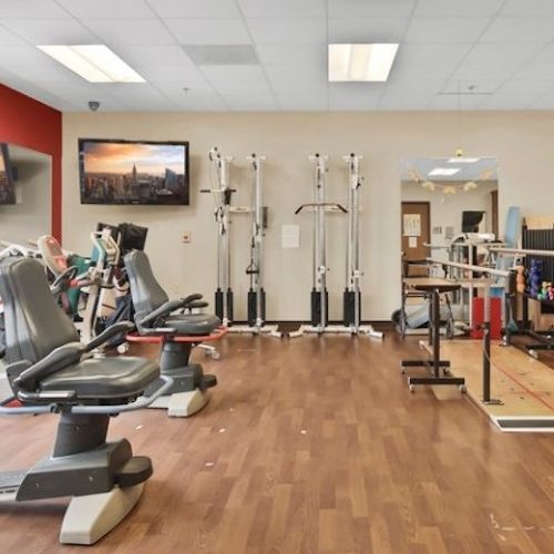 Bright and spacious rehab gym with modern equipment fostering active community wellness.