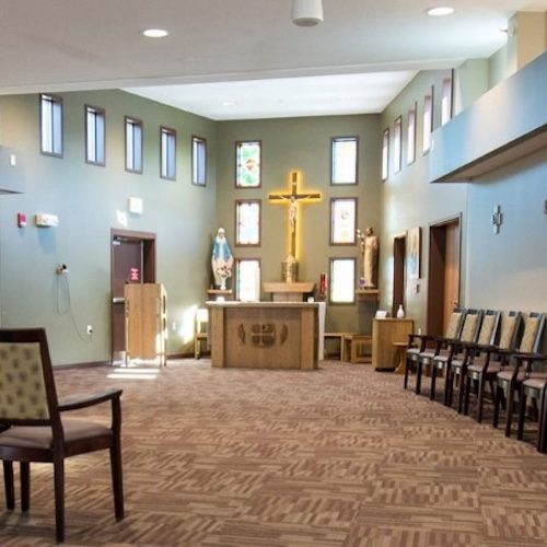 Bright, peaceful chapel setting with ample seating fostering a welcoming community atmosphere.