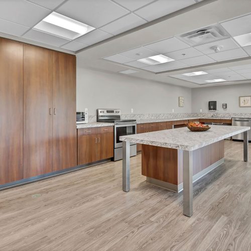 Spacious, well-equipped kitchen designed for community gatherings and shared meals.