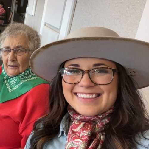 Image of associate Andrea with two female residents.