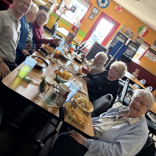 Seniors sitting around a table at a restaurant.