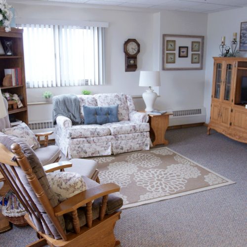 Bright living room with comfortable seating, soft lighting, and homey decor for relaxed gatherings.