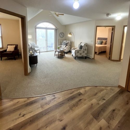 Spacious living area with comfortable seating, natural light, and a peaceful atmosphere for residents.