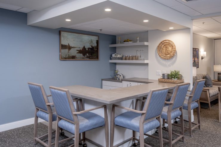 Communal dining area with high chairs, soft lighting, and inviting decor for social gatherings.