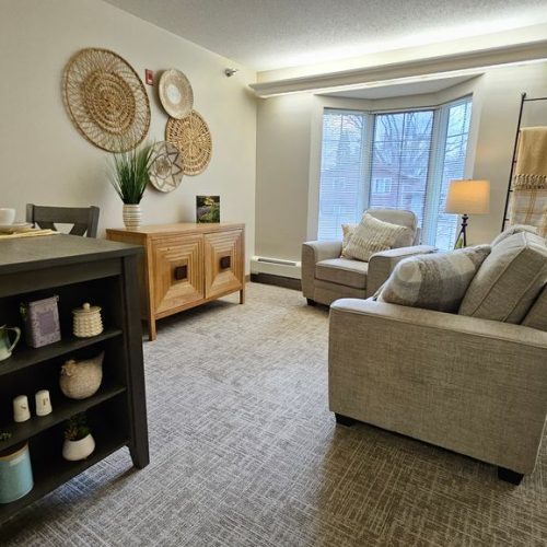 Bright, inviting living area with comfortable seating and tasteful decor fostering a welcoming community feel.