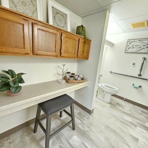 Bright, accessible bathroom with thoughtful decor and supportive features for comfort and safety.