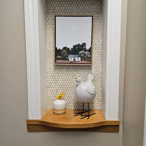 Welcoming entry nook with charming art and decorative accents, creating a warm, inviting atmosphere.