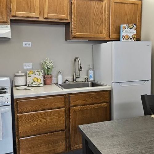 Well-equipped kitchen area with warm wood cabinetry and a welcoming dining space.