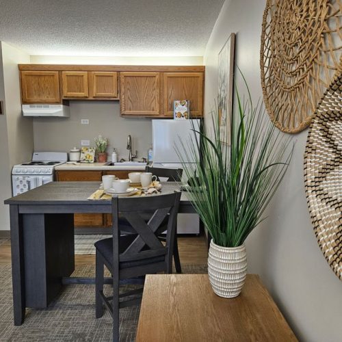 Inviting kitchen and dining space with warm wood accents and tasteful décor fostering community living.