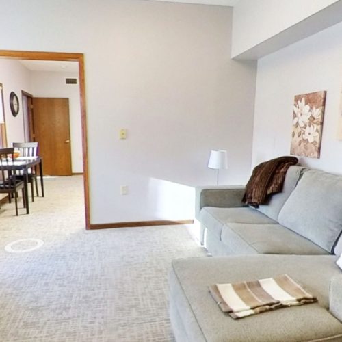 Bright living area with comfortable seating and dining space, designed for relaxation and community.