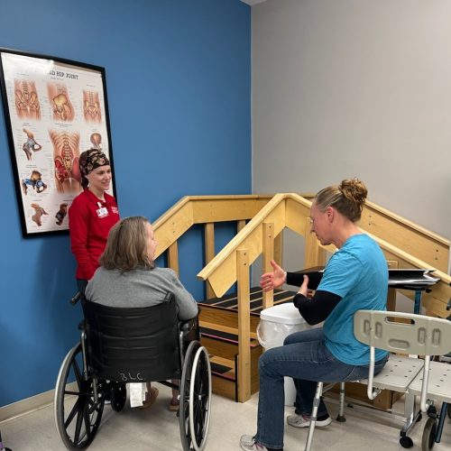 Resident in wheelchair getting physical therapy services from the physical therapist.