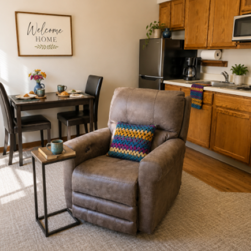 Comfortable living space with a recliner, dining table, and welcoming kitchen area.