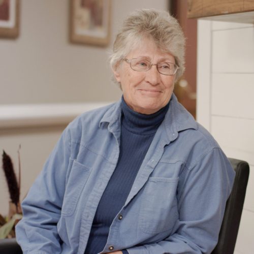 Senior female smiling at another senior female