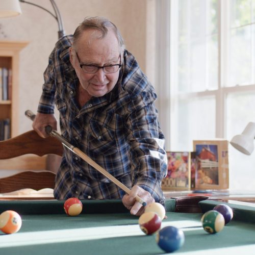 Senior gentleman playing pool.
