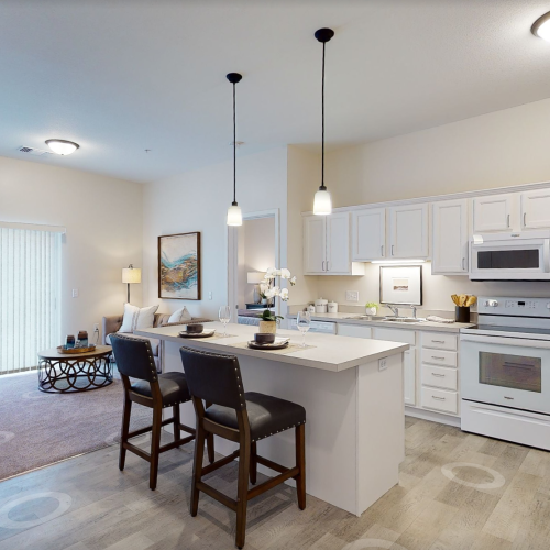Bright, inviting kitchen and living area with seating designed for shared meals and conversation.