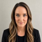 Professional woman with warm expression, representing trust and care in a supportive community.