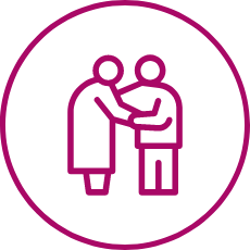 Two individuals sharing a warm, supportive moment within a caring community setting.