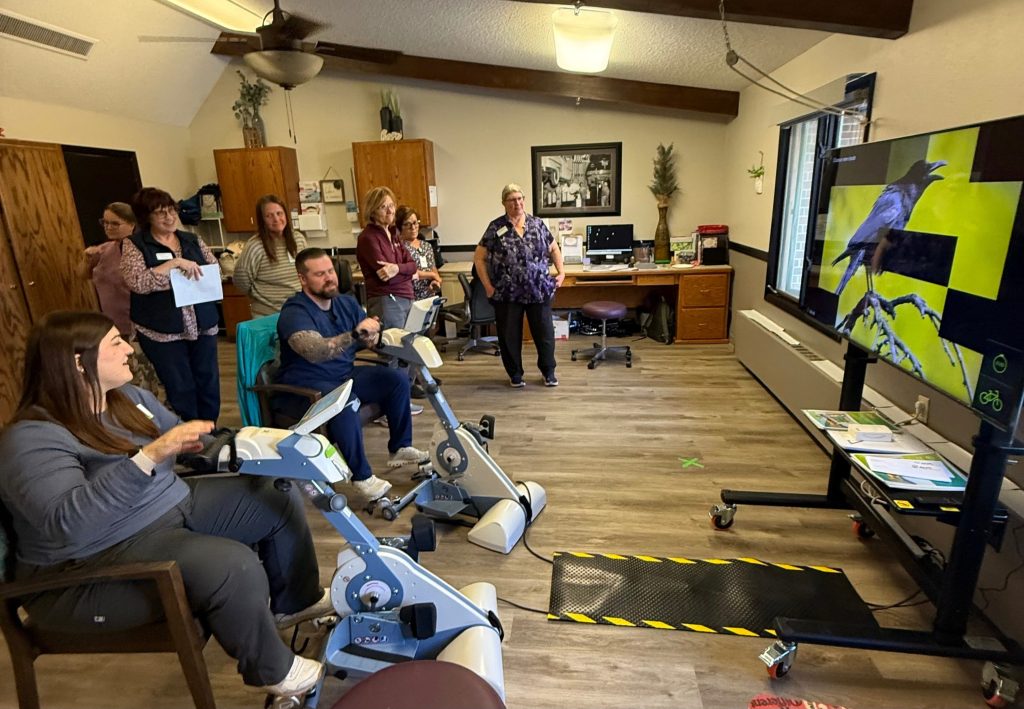 Two OT staff on OT bikes learning how to use the equipment.