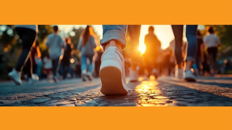 Residents and community members enjoying a peaceful group walk at sunset outdoors.
